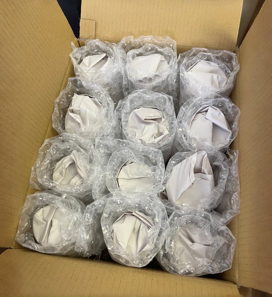 Individually wrapped fragile items fitted carefully into a moving box